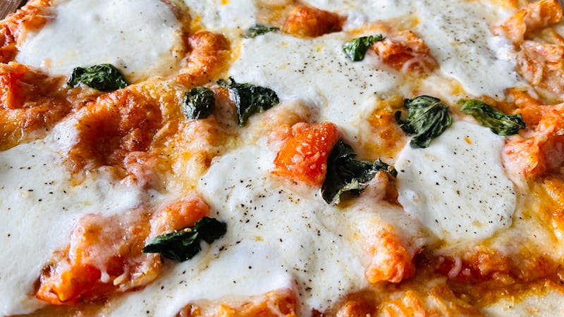 Classic Margherita thin crust pizza with basil